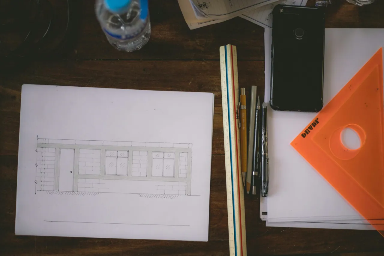 A building elevation drawing on a working desk