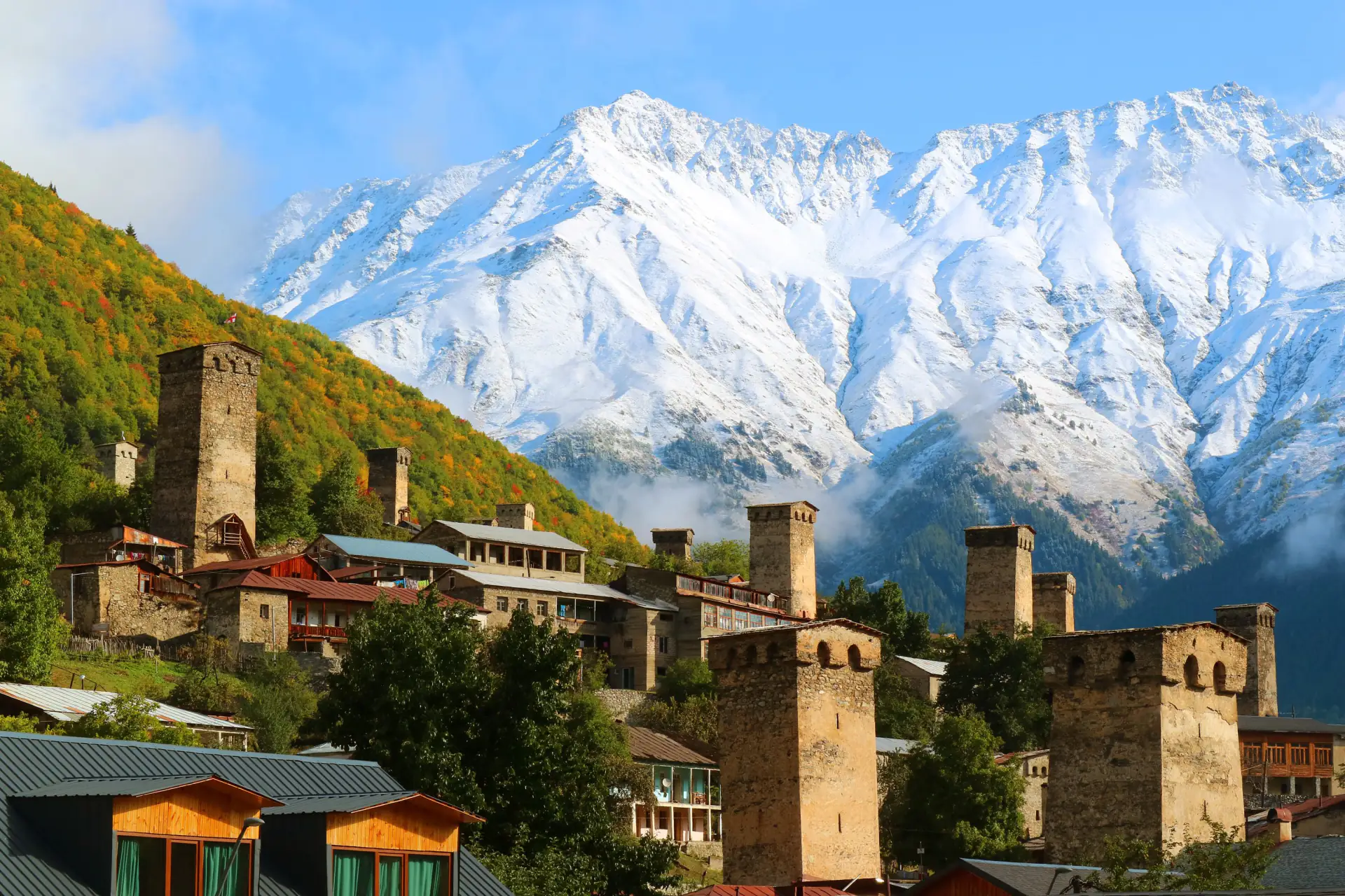 Svan towers in Mestia beneath the snow-covered Greater Caucasus